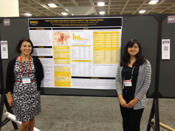 Dr. Mezuk and Dr. Concha standing with a poster